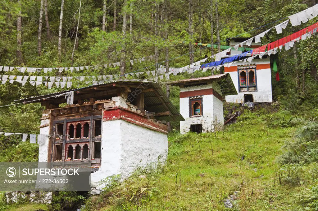A series of hydro-powered prayer wheels turned by water, en route to Tango Monastery, with little clay tsha tsha images carefully balanced on the window ledges.