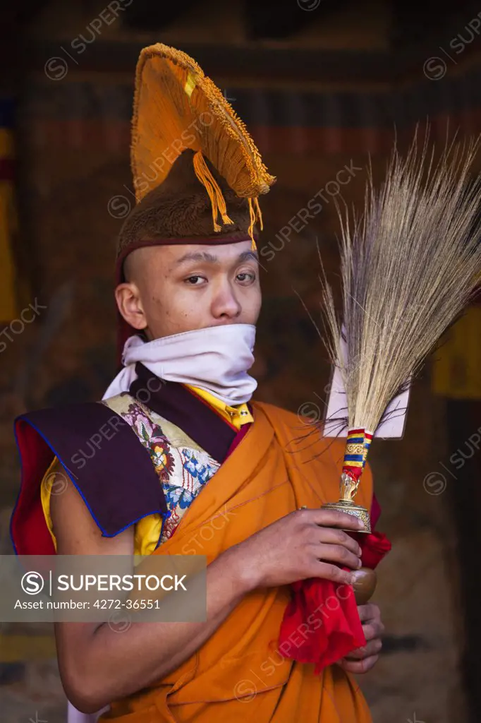 A monk in ceremonial robes prepares for the Tamshingphala Choepa festival in Bumthang.
