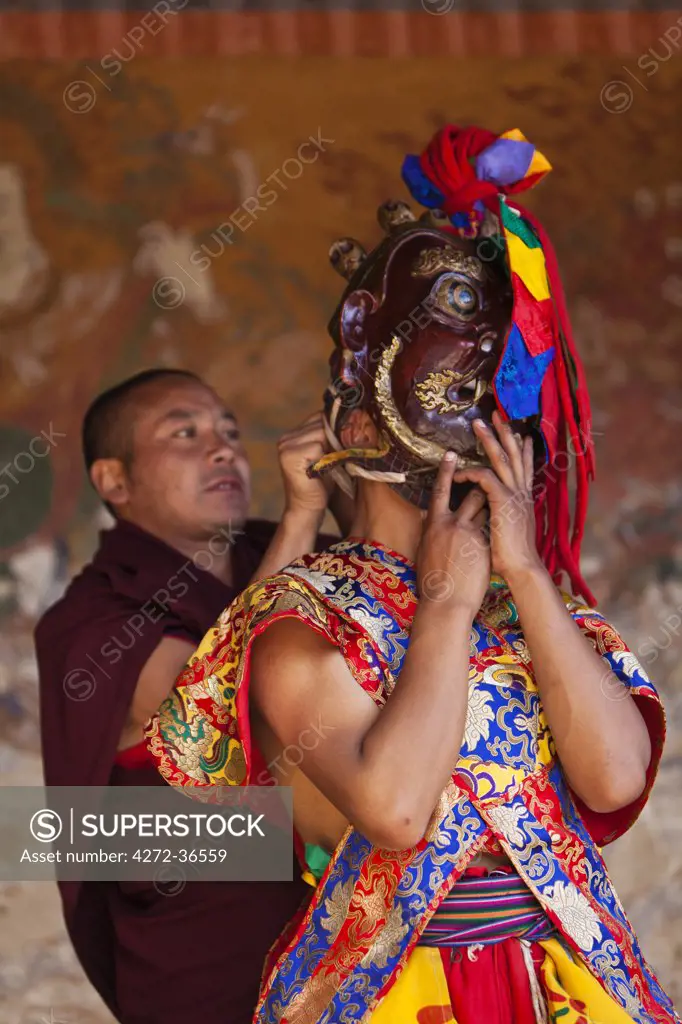 A masked dancer preparing for the Tamshingphala Choepa festival in Bumthang.