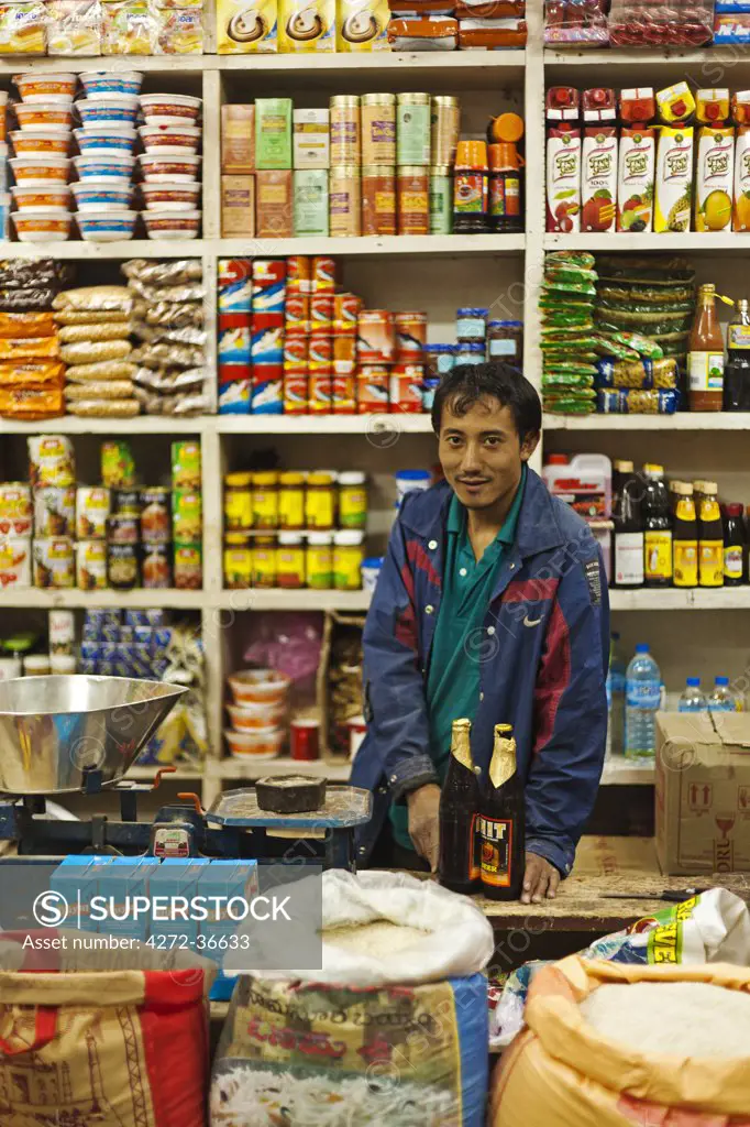 A shopkeeper in a general store in Thimphu.