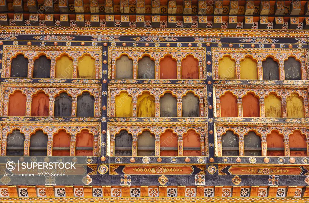 Ornately painted wooden windows at the 17th century Paro Dzong, one of Bhutan's most impressive and well-known dzongs.