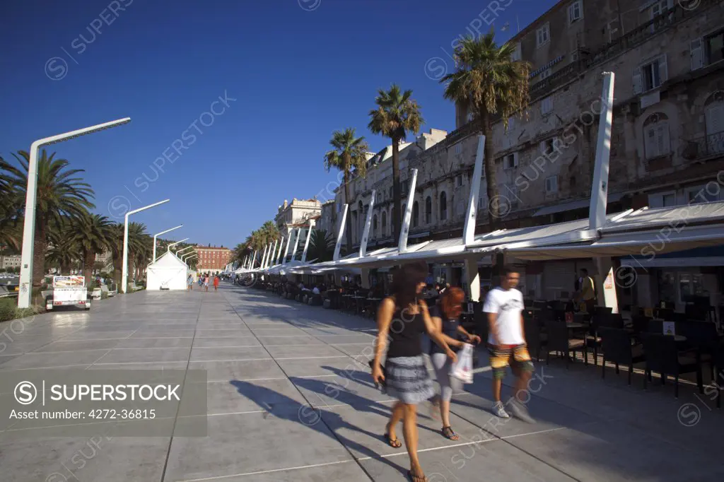 Croatia, Split, Central Europe. Young people walking in the historic centre in front of the harbour. UNESCO