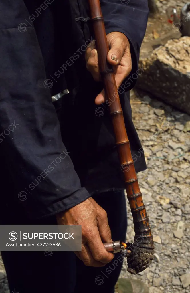 A villager lights his pipe
