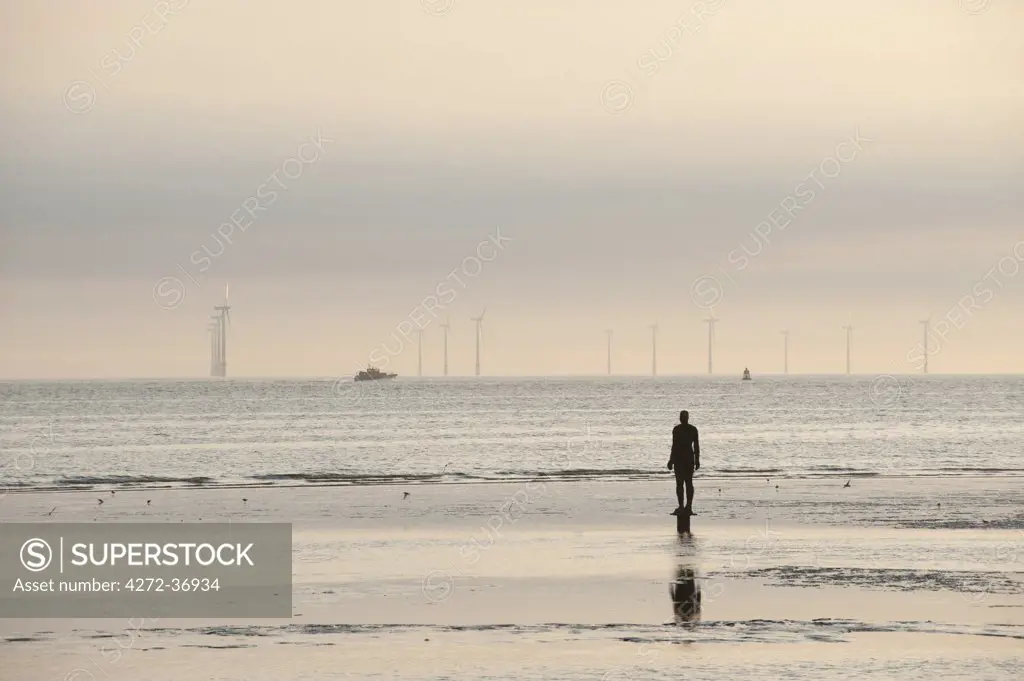 Another Place by artist, Anthony Gormley. The figures are spread out along three kilometers of Crosby Beach, and stretching almost one kilometre out to sea.