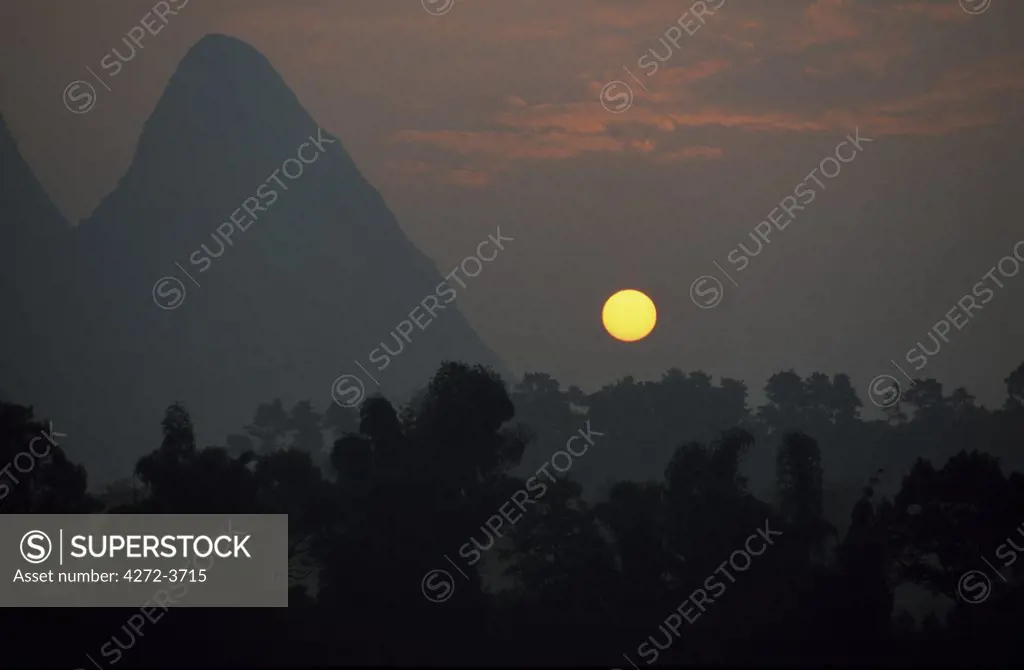 Sunrise over limestone hills.