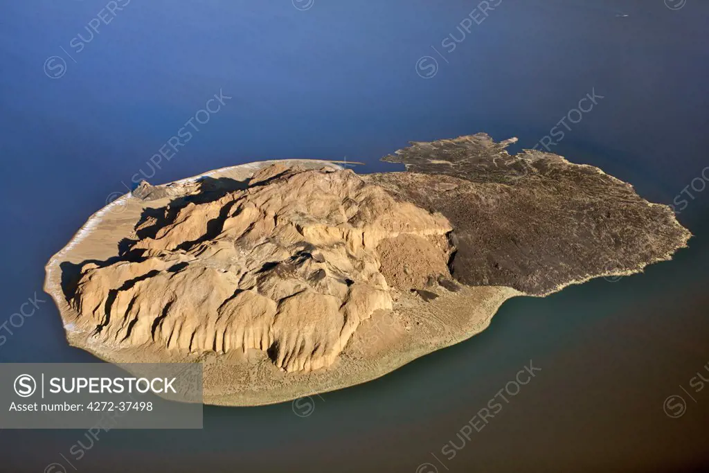 The small volcanic island, known as Cathedral Rock, is surrounded by the highly alkaline waters of seasonal Lake Logipi in the inhospitable, low-lying Suguta Valley.