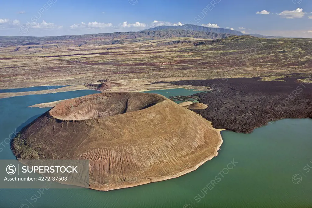 The perfectly shaped volcanic cone called Nabuyatom juts into the jade waters of Lake Turkana.