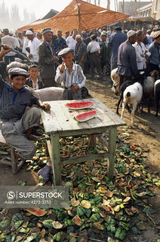 Uigur boys sell water melons from their stall at Kashgar's Sunday Market
