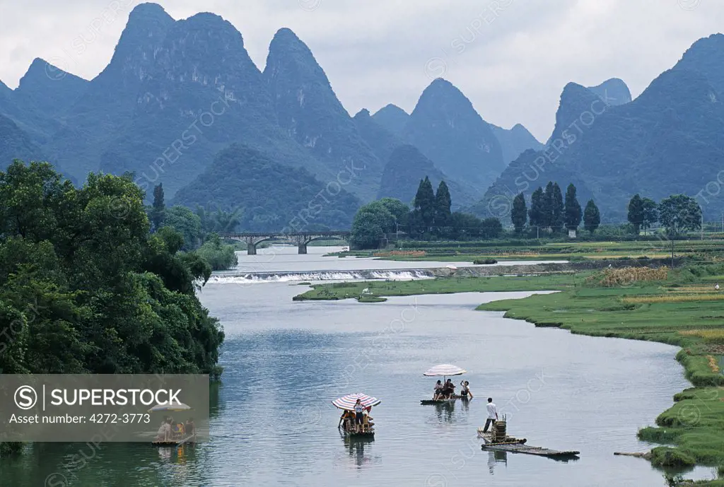 Yulong River, Nr Yangshuo, Guangxi Province Tourists pole bamboo rafts o the placid river set amidst some of South China's finest karst scenery.