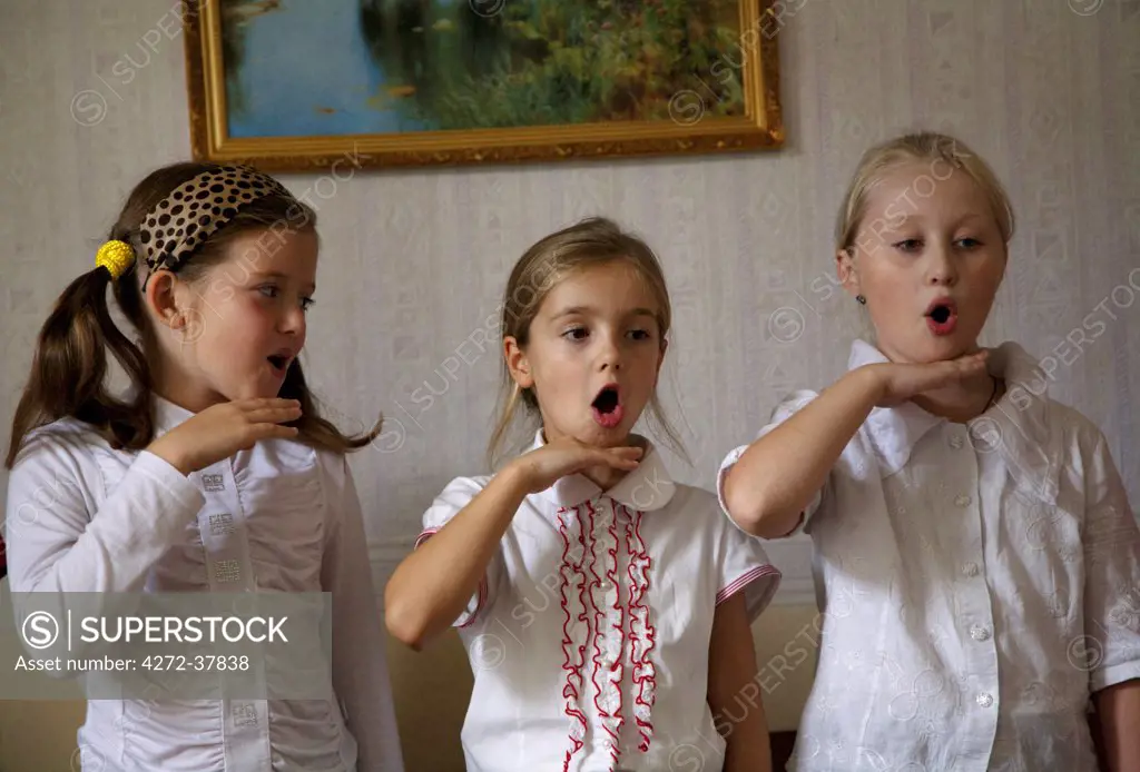 Sakhalin, Yuzhno-Sakhalinsk, Russia; Three girls during singing class in Gimnasia no.3, the art college in the Capital city