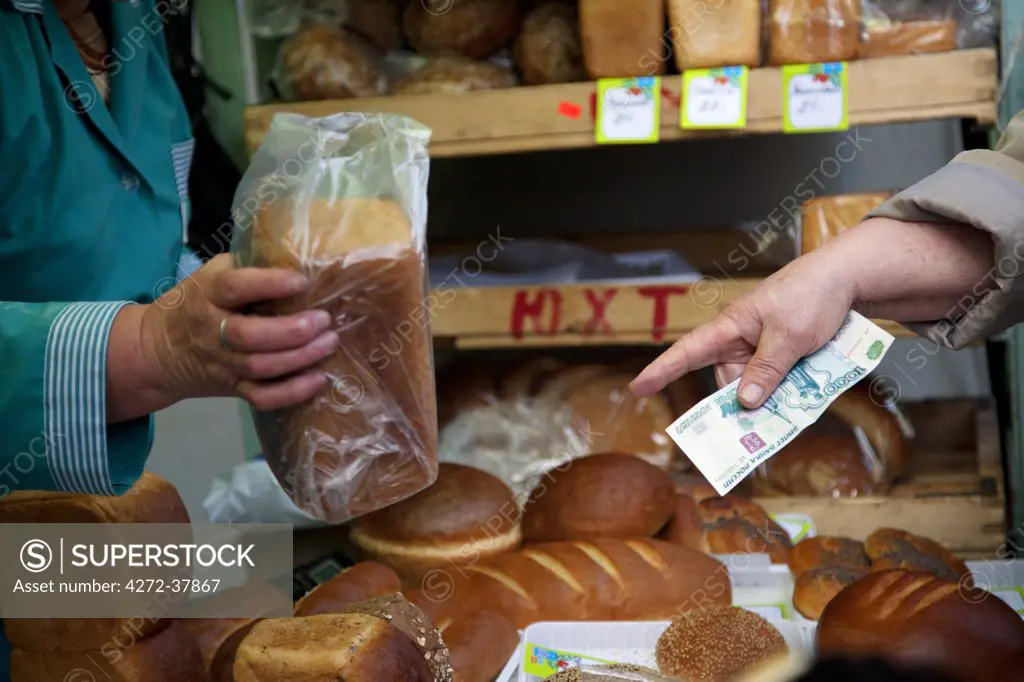 Sakhalin, Yuzhno-Sakhalin, Russia; Buying bread from a local kiosk