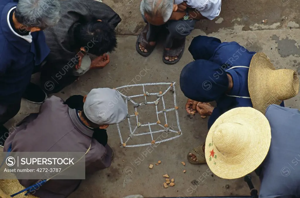 Townsfolk play an impromptu game on the pavement near Chaoyang Gate