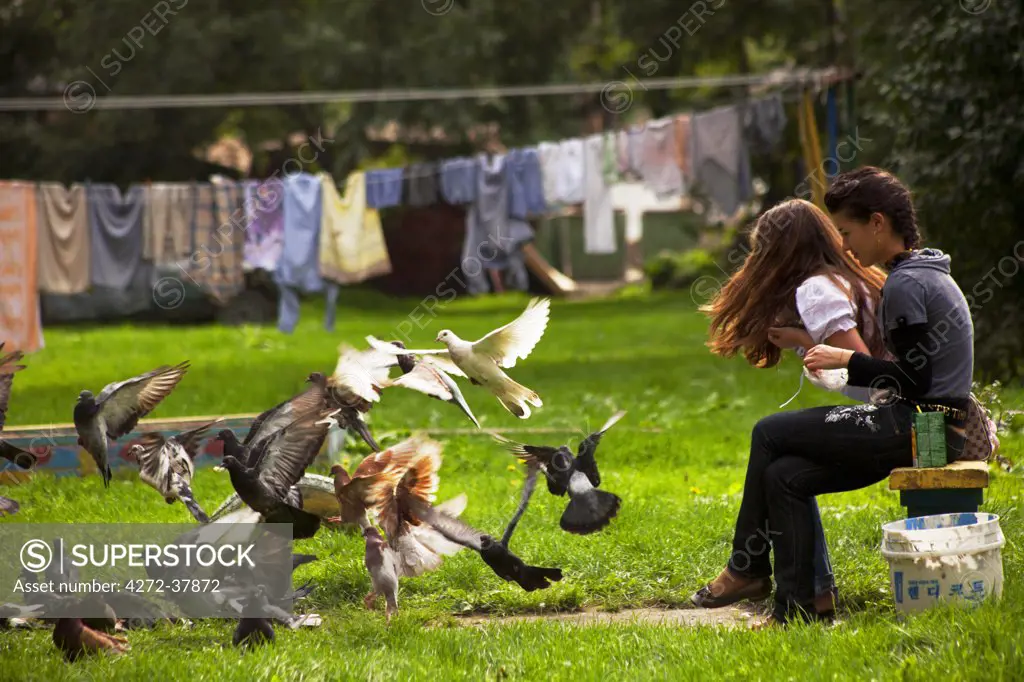 Sakhalin, Yuzhno-Sakhalin, Russia; Two local young women feeding pigeons