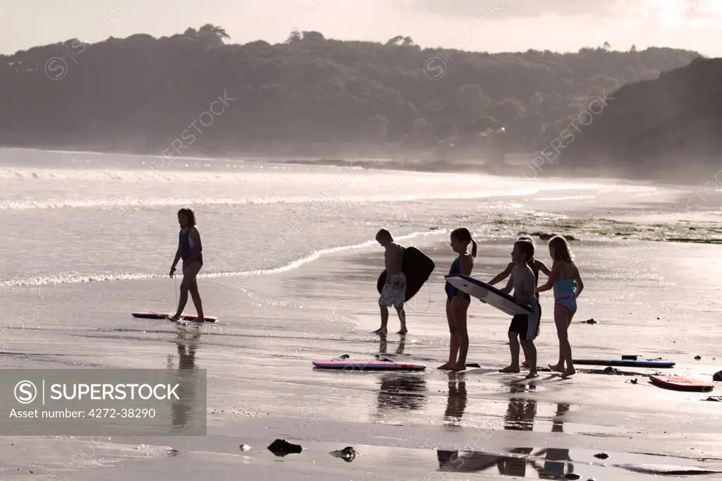 A group of children about to go bodyboarding, Amroth, Pembrokeshire, Wales.