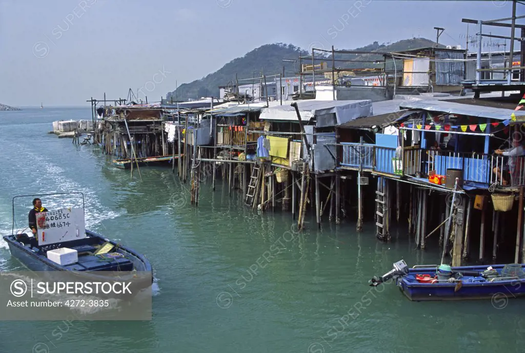 A fisherman returns to the stilt house village of Tai O, on Lantau Island, Hong Kong. The village, predominantly Tanka, was once a centre for trade and fishing, but now relies heavily on tourism and its local seafood industry.