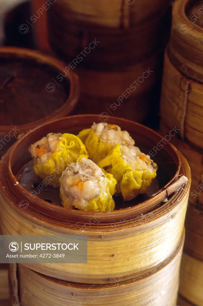 Dim sum delicacies are stacked in steaming bamboo baskets in a Kowloon restaurant, Hong Kong