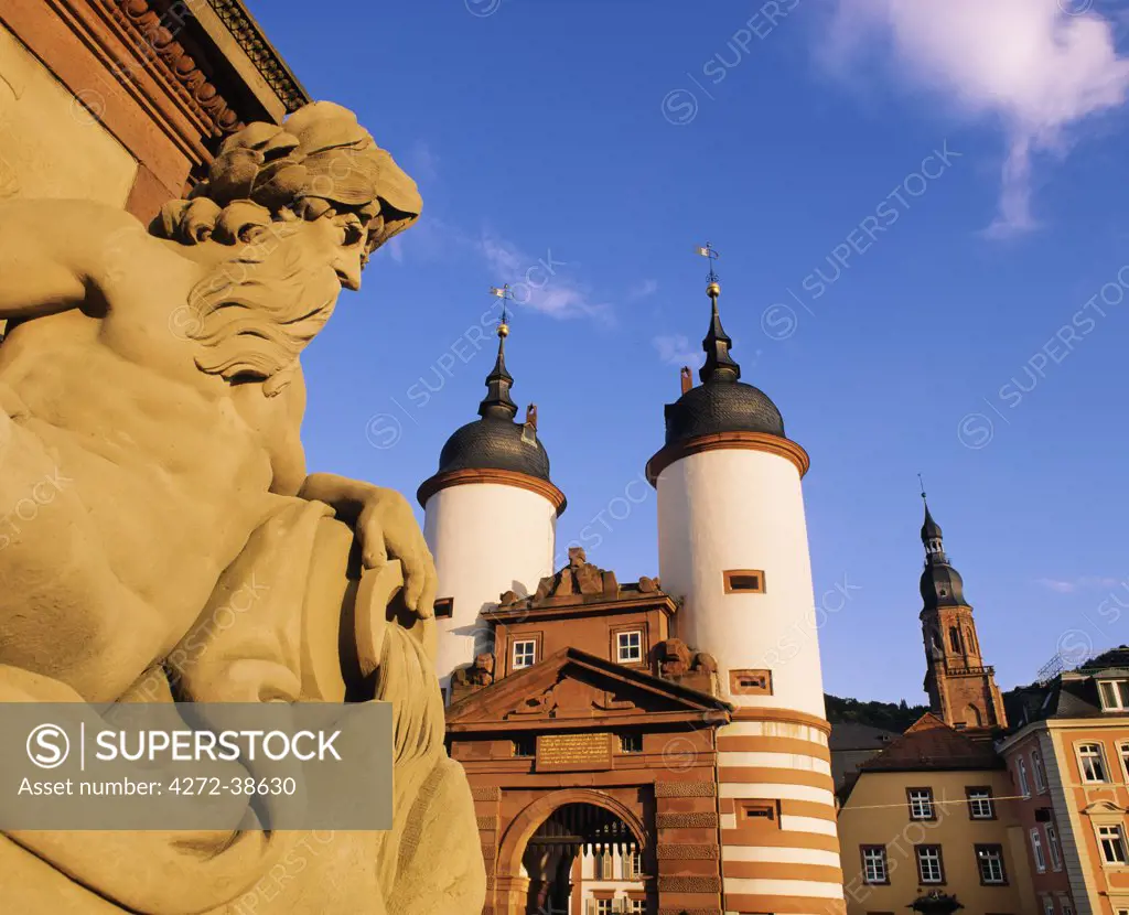 Germany, Bavaria, Heidelberg, Statue on bridge and Heidelberg gate
