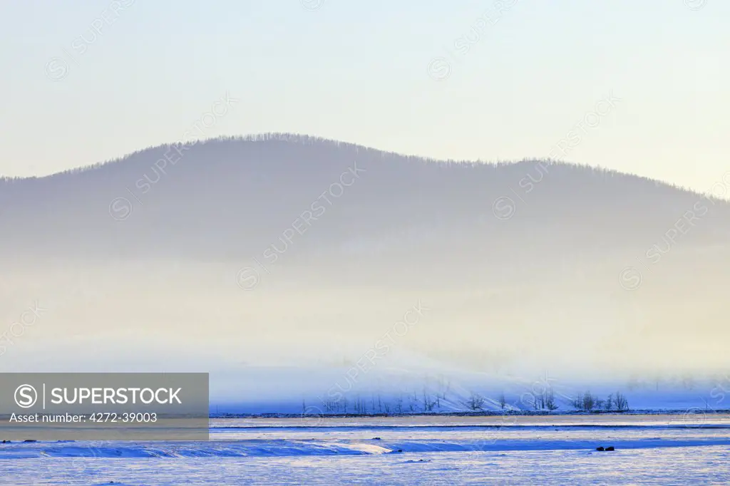 Mongolia, Ovorkhangai, Orkhon Valley. The Orkhon Valley shrouded in mist in the early evening.
