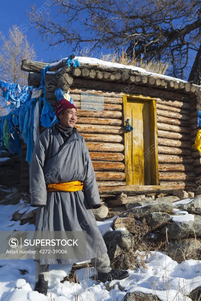 Mongolia, Ovorkhangai, Orkhon Valley. A Mongolian man stands by a hut at hot springs in the Orkhon Valley.