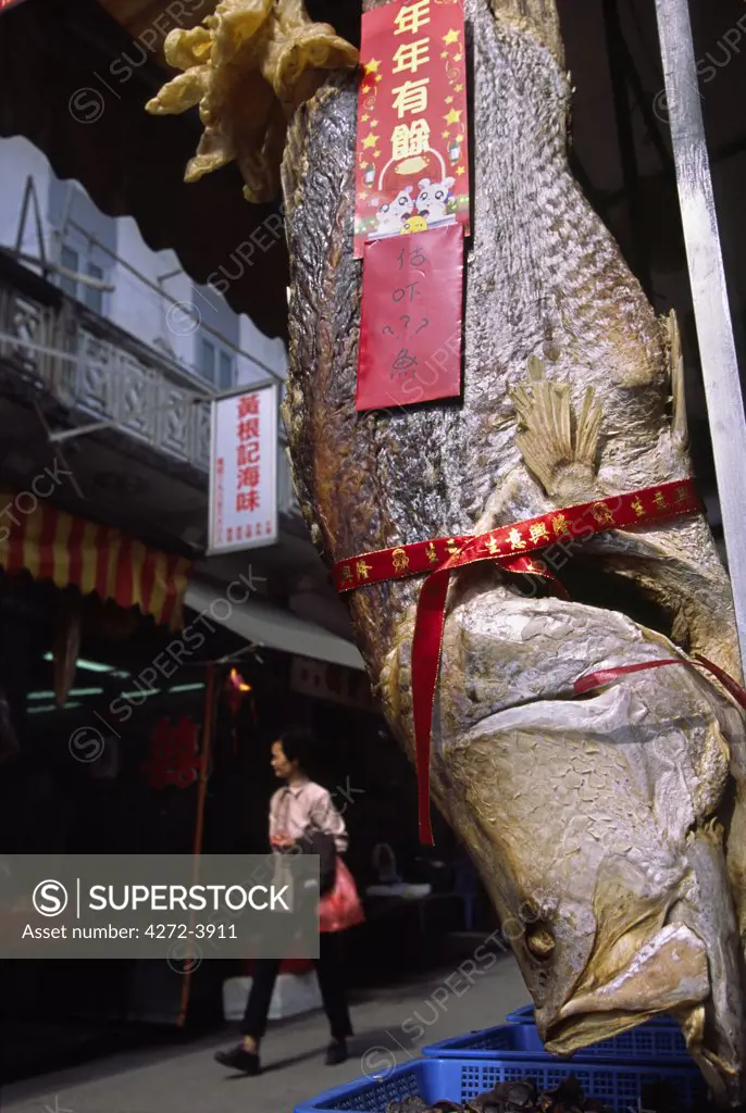 Dried fish hangs gift wrapped in the streets of Tai O, on Lantau Island in Hong Kong. The quiet Tanka village is renowned for its fresh and dried seafood and is a popular destination for daytrips in Hong Kong.