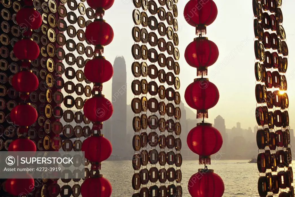 A curtain of Chinese New Year decorations frame a view of Victoria Harbour from Tsim Sha Tsui, in Hong Kong.