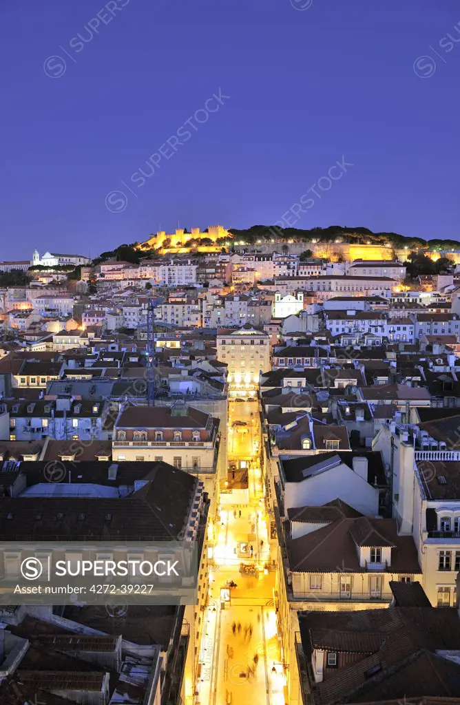 The historical centre and the Sao Jorge castle at dusk. Lisbon, Portugal