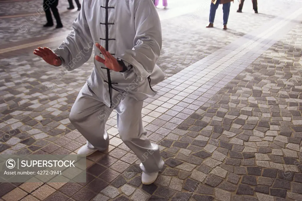 The hands of a T'ai chi master as he takes a class through the slow movements of the art, on the waterfront at Tsim Sha Tsui in Hong Kong