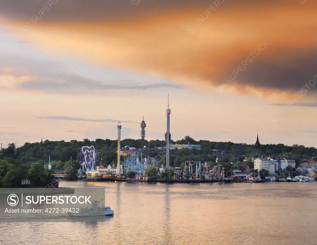 Sweden, Stockholm, Grona Lund Tivoli, passenger ferry in bay at dusk.