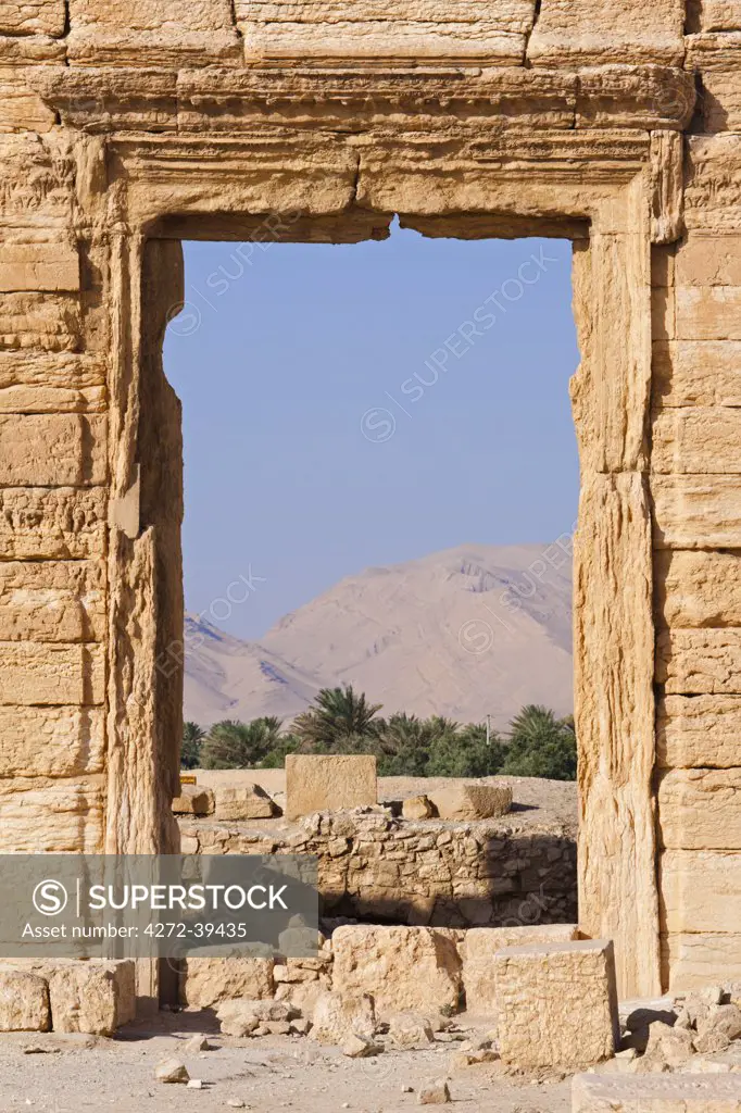 Syria, Homs Governate, Palmyra. Oasis seen through a doorway.