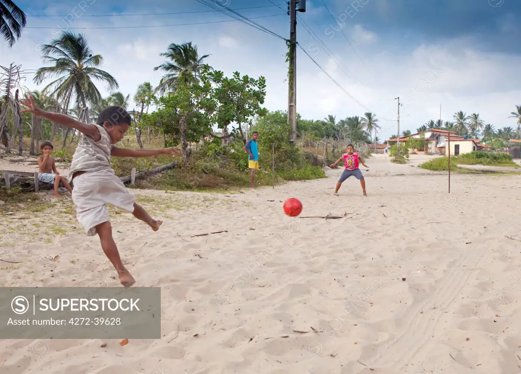 South America, Brazil, Maranhao, kids playing football in Atins in the Lencois Maranhenses national park