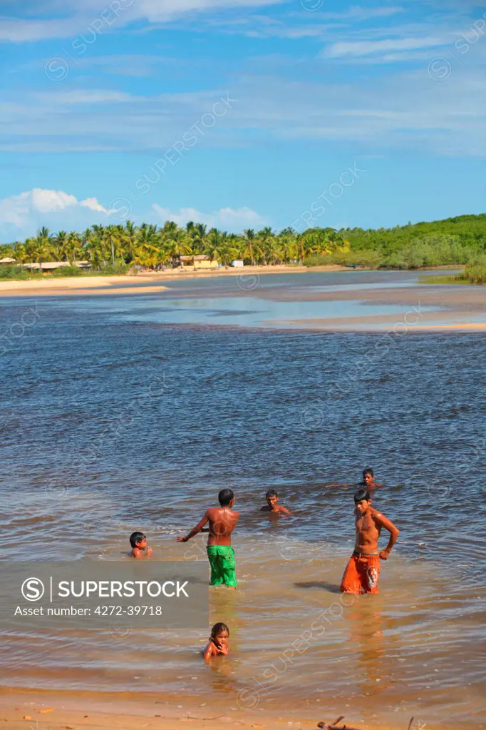 South America, Brazil, Bahia, Ponta do Corumbau, Parque Nacional do Monte Pascoa, indigenous Pataxo children from the Aldeia Xando community swimming in the Corumbau river