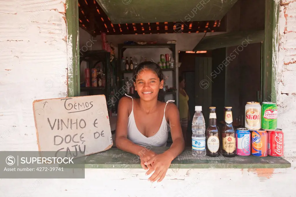 South America, Brazil, Maranhao, shop girl shop selling Cashew wine and sweets in Mandacaru village on the Preguica river in the Lencois Maranhenses National Park