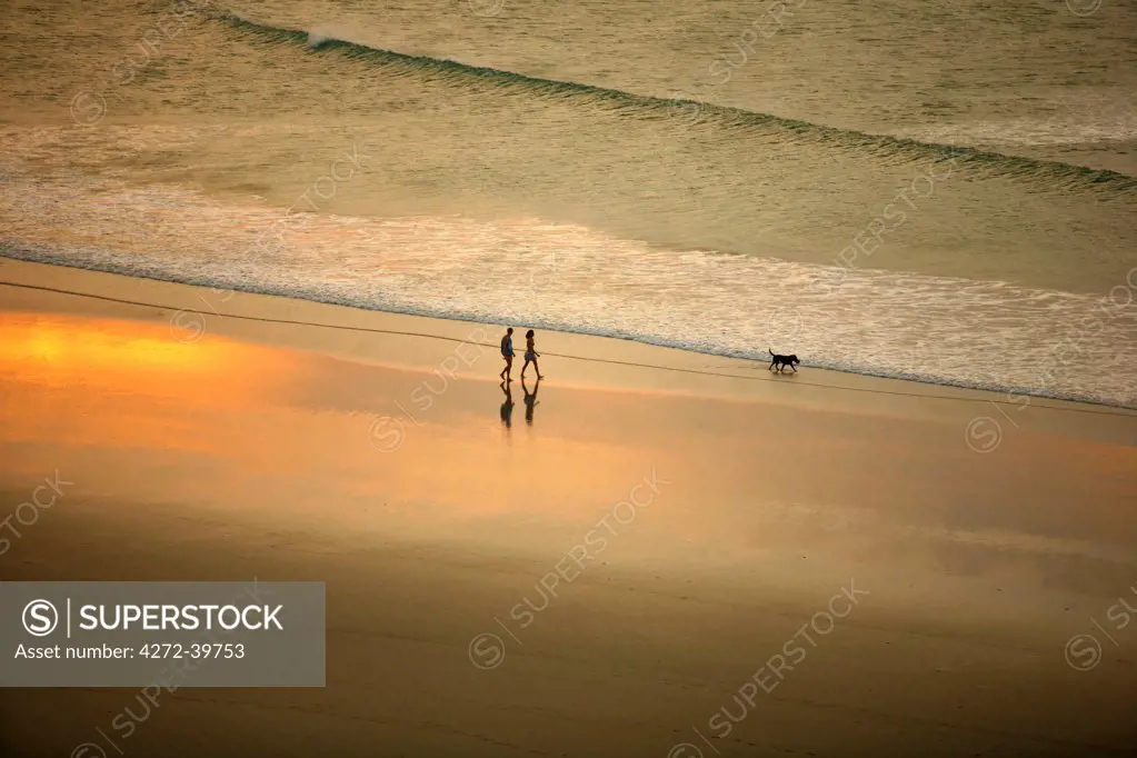 South America, Brazil, Ceara, Jericoacoara, A couple walk along the beach at sunset seen from the Sunset dune