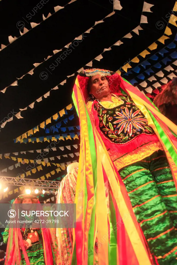South America, Brazil, Maranhao, Sao Luis, a costumed dancer at the Bumba Meu Boi festival at the Arraial Lagoa da Jansen