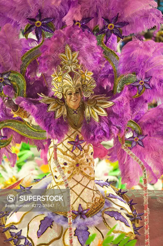 South America, Rio de Janeiro, Rio de Janeiro city, costumed transvestite dancer in a huge feather headdress at carnival in the Sambadrome Marques de Sapucai