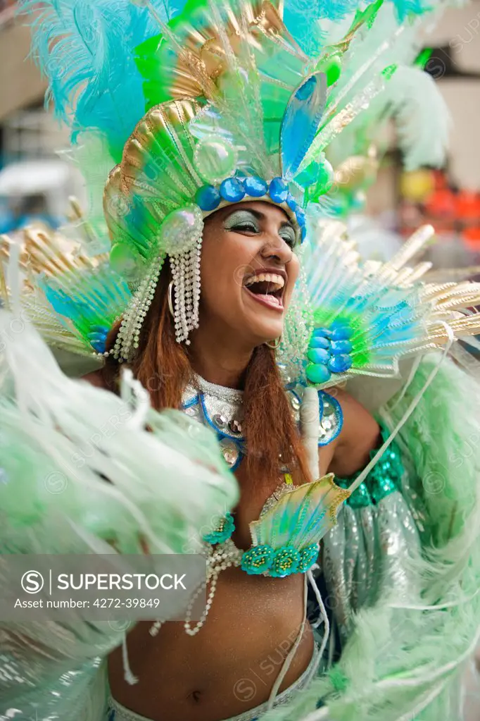 South America, Rio de Janeiro, Rio de Janeiro city, a costumed dancer in a feather headdress at carnival in the Sambadrome Marques de Sapucai