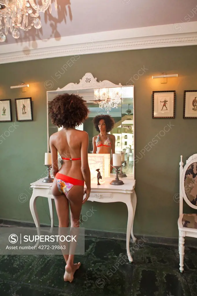 Brazil, Rio de Janeiro city, Gavea, La Maison Hotel, model in a Brazilian bikini standing in front of a mirror in the La Maison boutique hotel MR PR