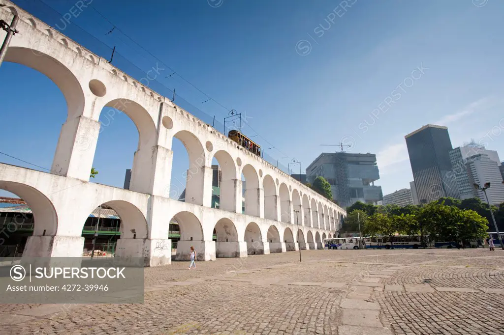 South America, Brazil, Rio de Janeiro, the Lapa arches aqueduct and tram line with the Petrobras building behind