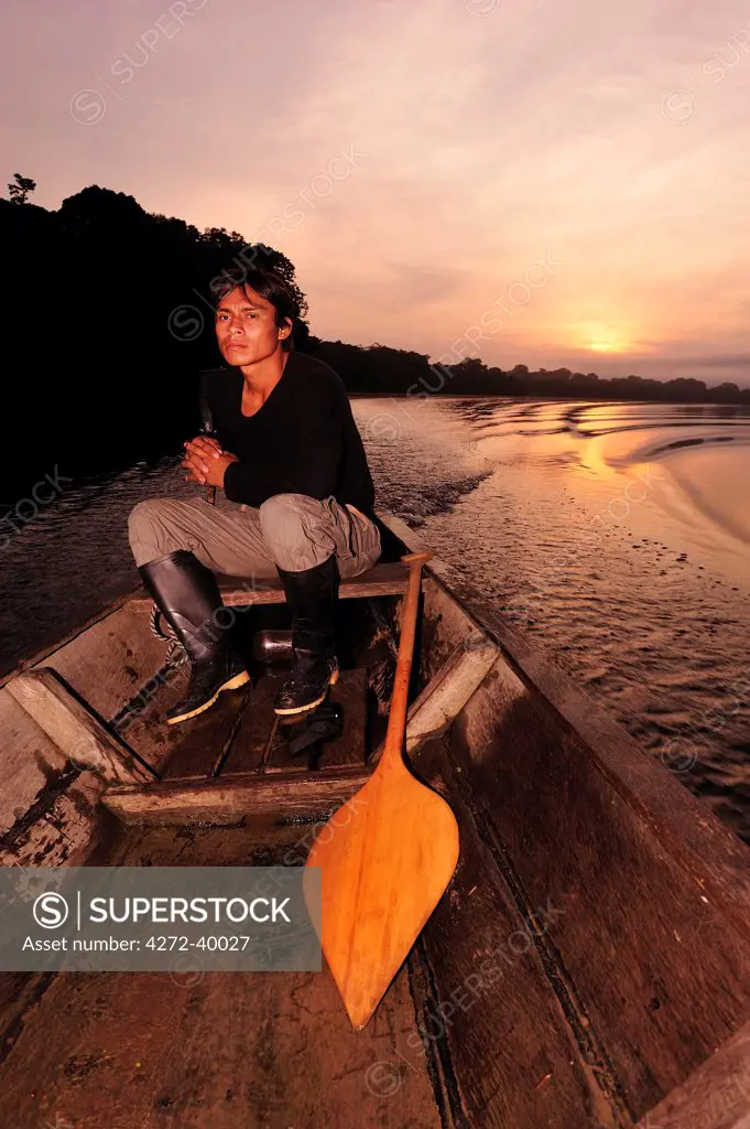 Man in dugout canoe on the Lago de Tarapoto, Amazon River, near Puerto Narino, Colombia