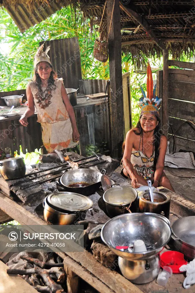 Two Ticuna women in a kitchen, Ticuna Indian Village of Macedonia, Amazon River, near Puerto Narino, Colombia
