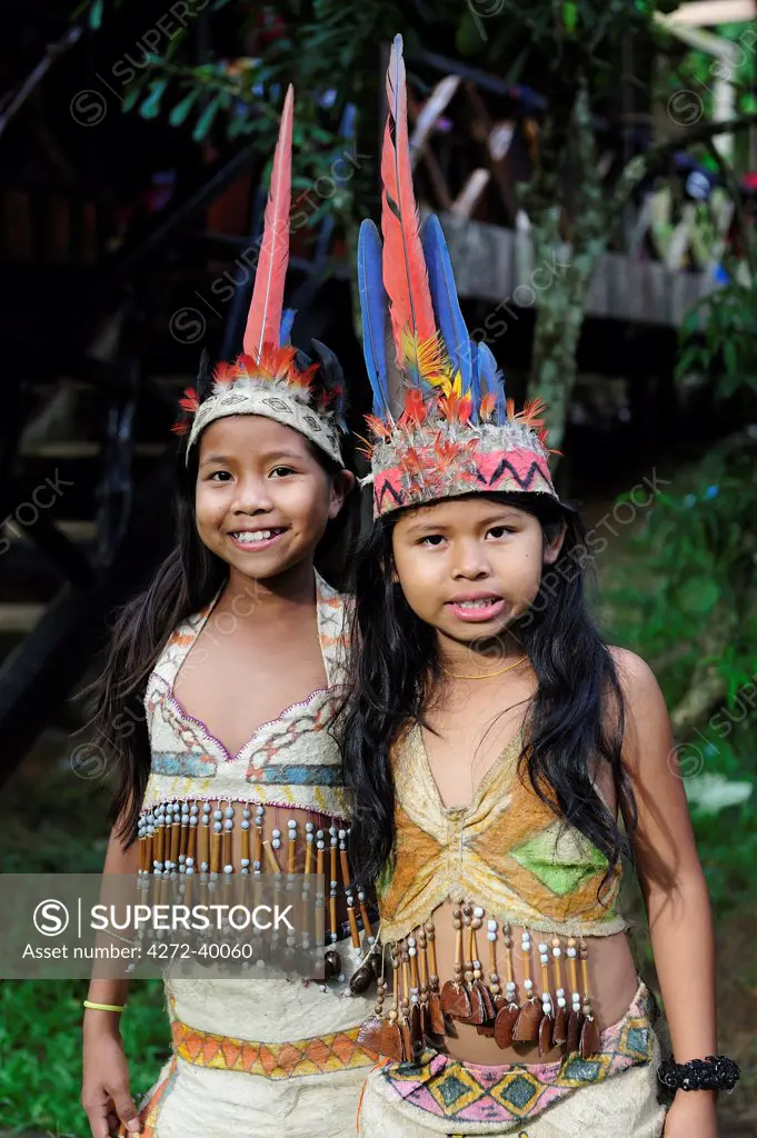 Ticuna girls wearing head dress, Ticuna Indian Village of Macedonia, Amazon River,near Puerto Narino, Colombia