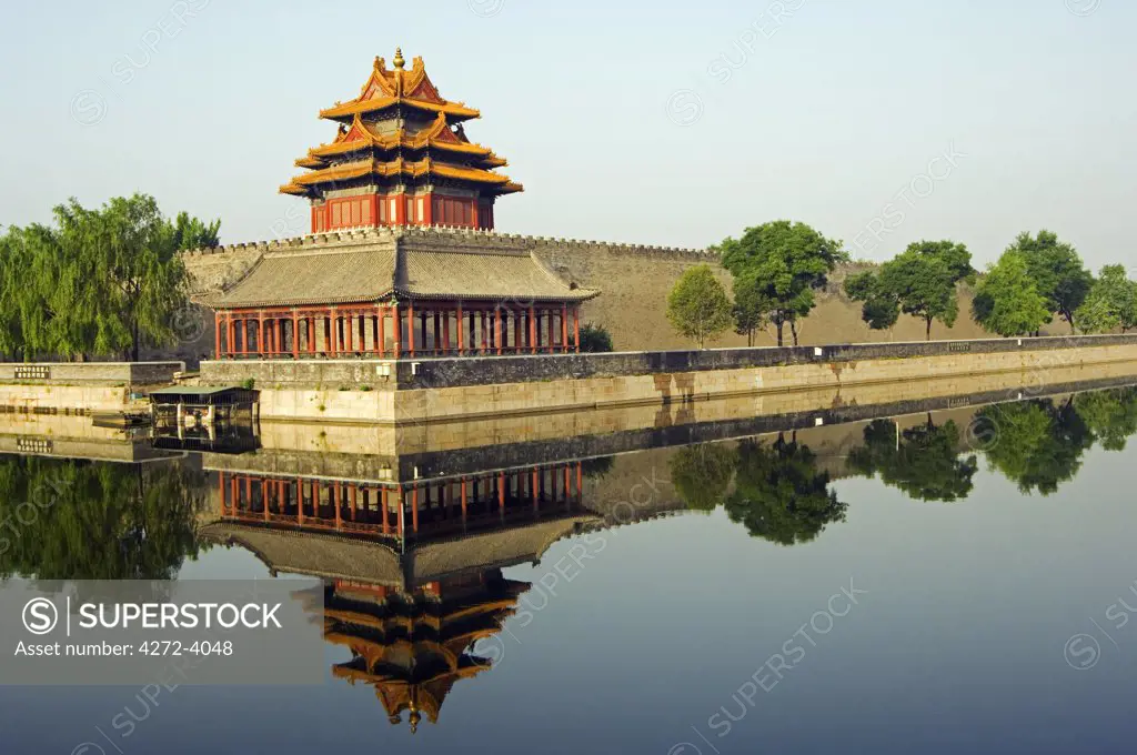 A reflection of a Palace Wall Tower surrounded by the moat of The Forbidden City Palace Museum, Zijin Cheng, Beijing, China