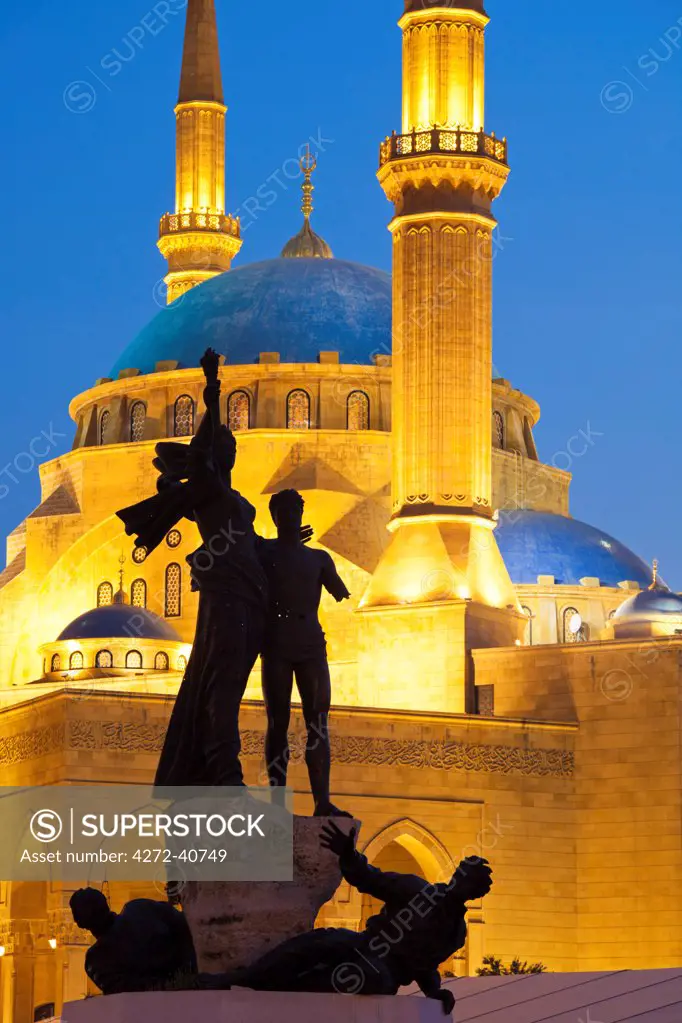 Lebanon, Beirut. Statue in Martyrs Square and Mohammed AlAmin Mosque at dusk.