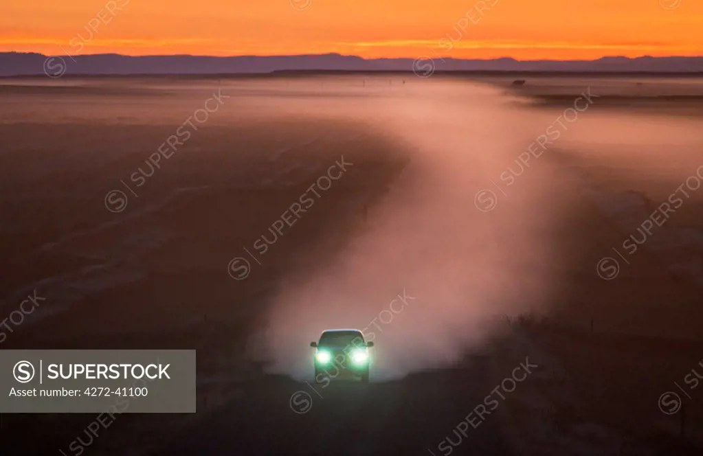 Car on gravel road in Badlands, South Dakota, USA