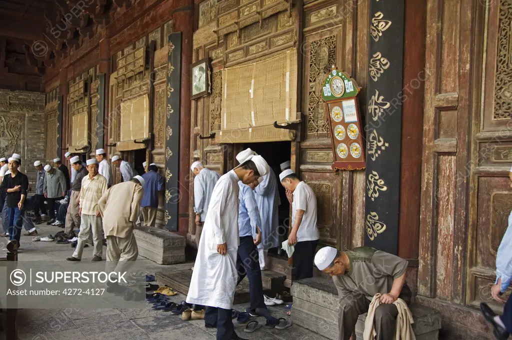 Men going to pray at The Great Mosque located in the Muslim Quarter, home to the city's Hui community, Xian City, Shaanxi Province, China