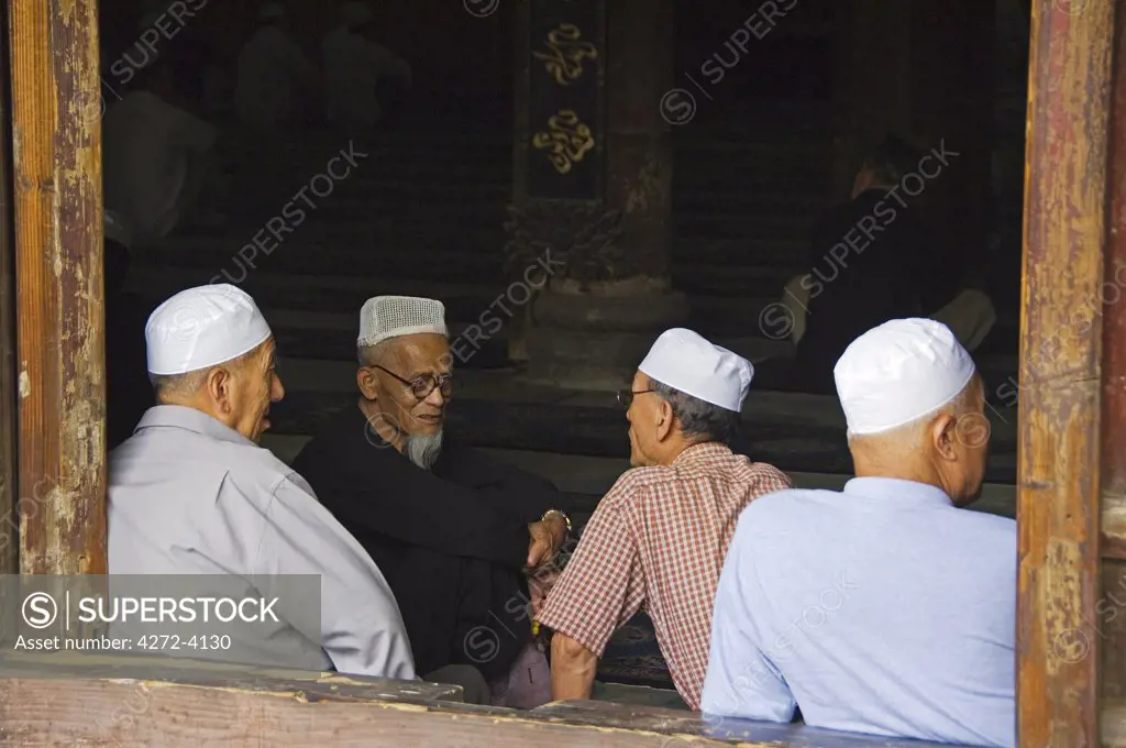 Men in the prayer hall at The Great Mosque located in the Muslim Quarter, home to the city's Hui community, Xian City, Shaanxi Province, China