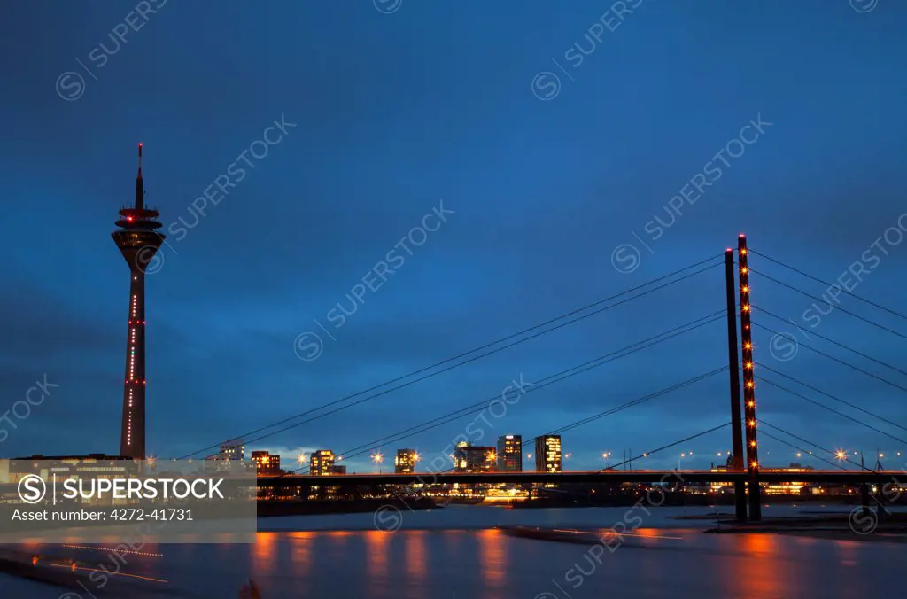 Dusseldorf, North Rhine Westphalia, Germany, The Theodor Heus Bridge and the Rheinturm Tower prominent against a dramatic sunset