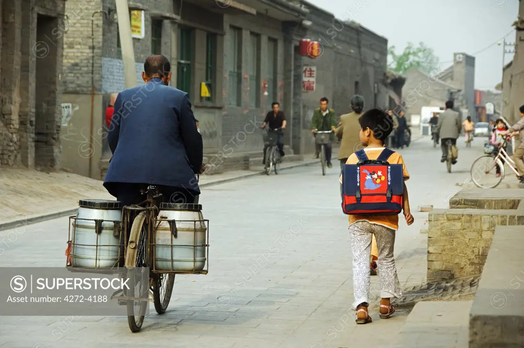 A child walking to school in the historic old town of Pingyao, Shanxi Province, China