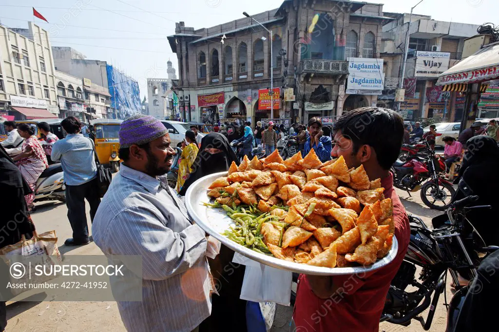 India, Andhra Pradesh, Hyderabad. A street vendor sells fresh samosas in the Old City of Hyderabad.