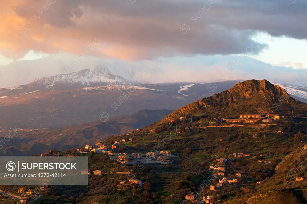 Taormina, Sicily, Italy, The Etna, Sicilys active volcano in dramatic light in the background and hill in the foreground